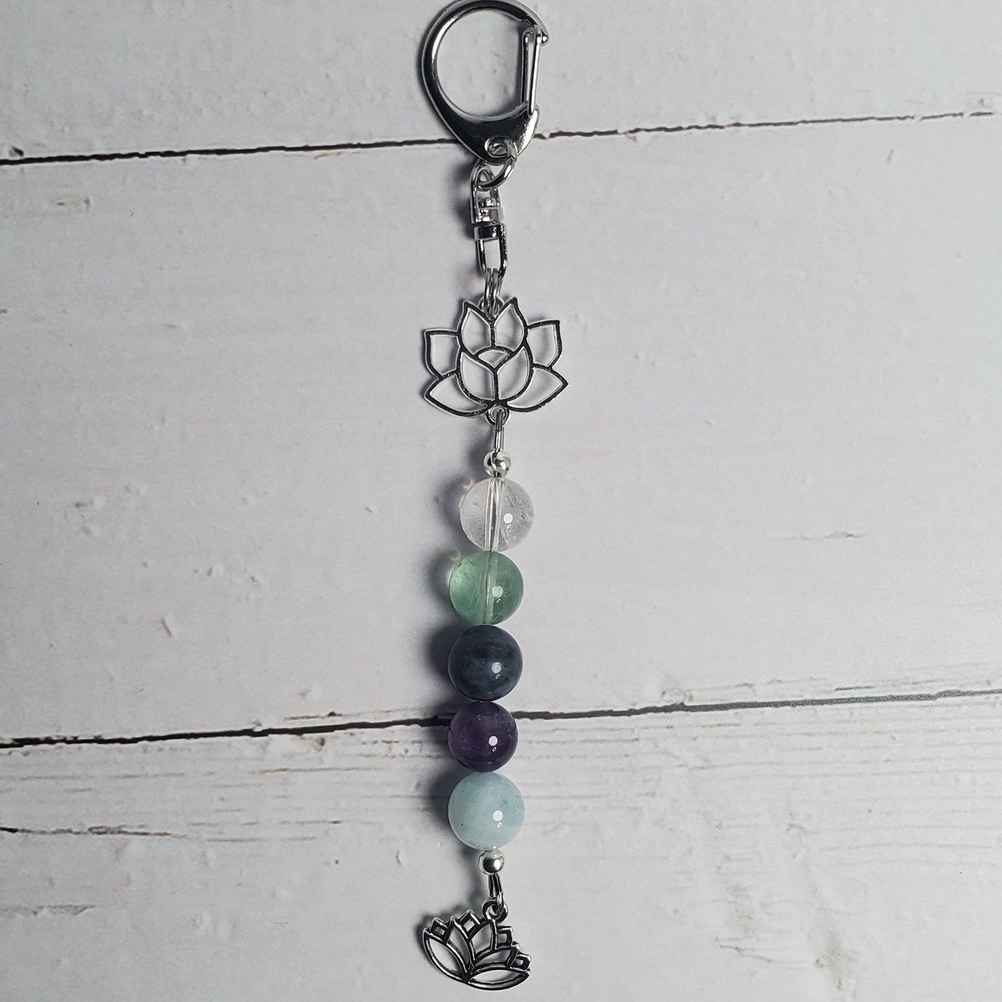 Keychain with beads and a metal clasp on a white wooden surface