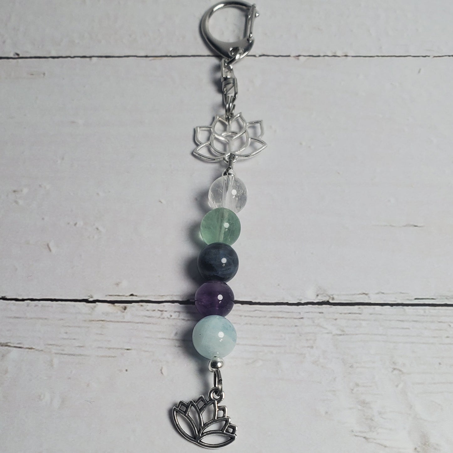 Intention Clip with beads on a light wooden surface