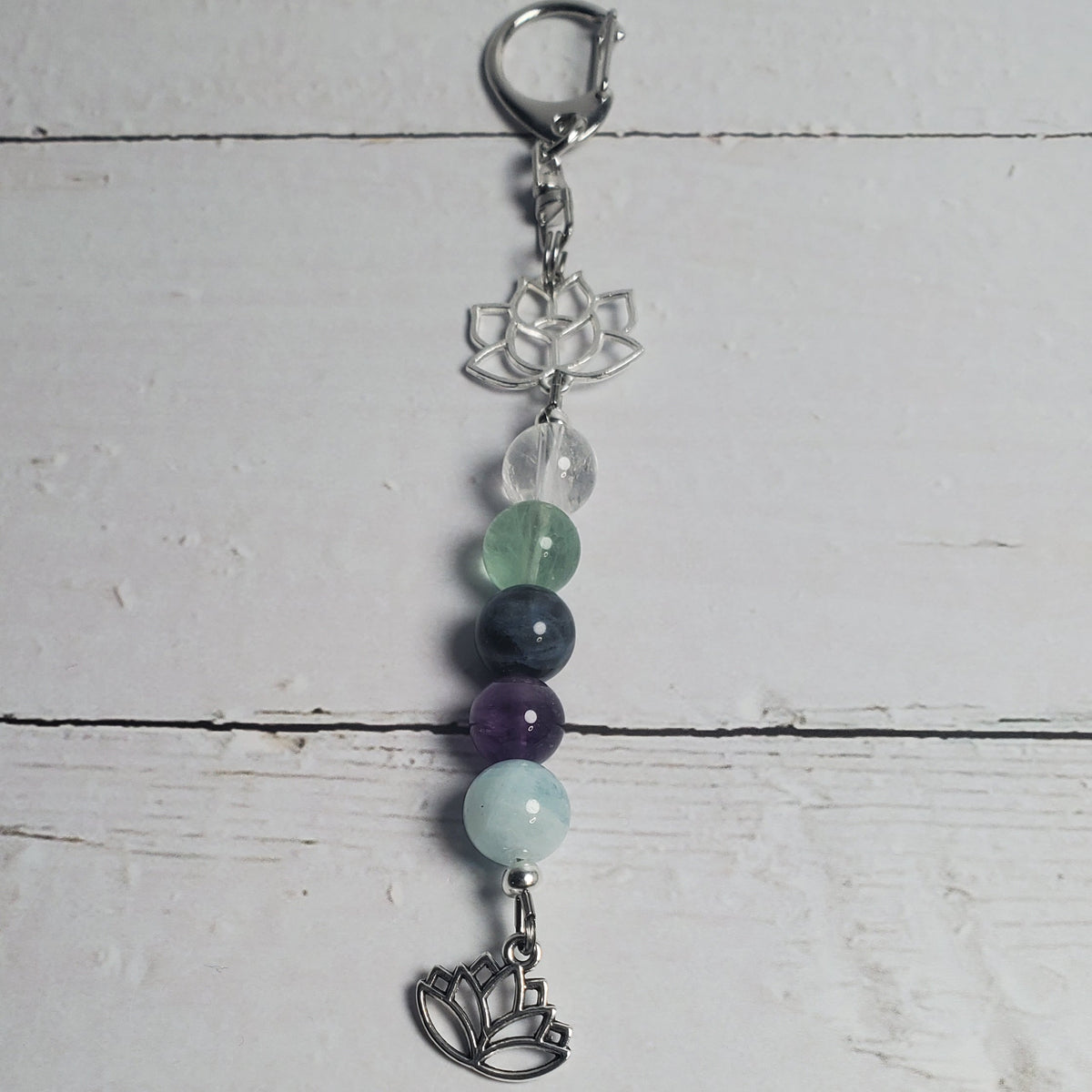 Intention Clip with beads on a light wooden surface