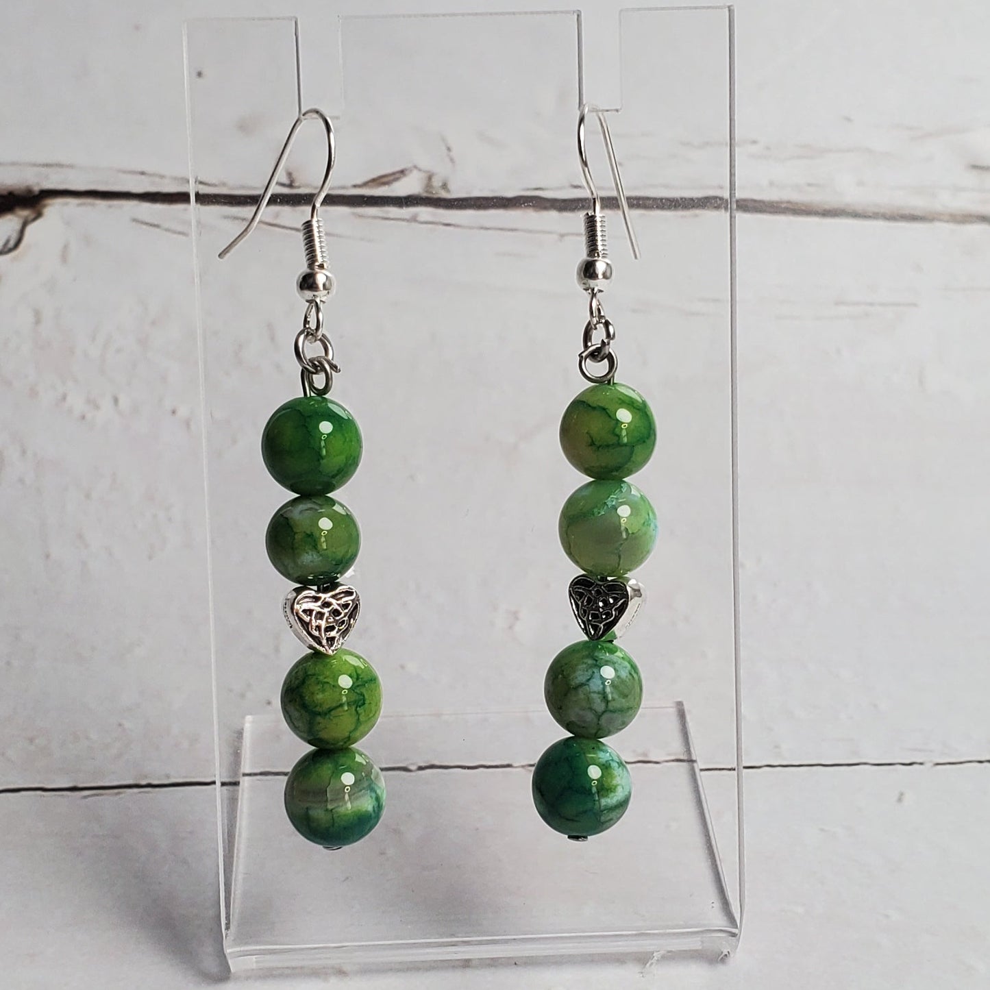 Green beaded bracelet on a white wooden surface