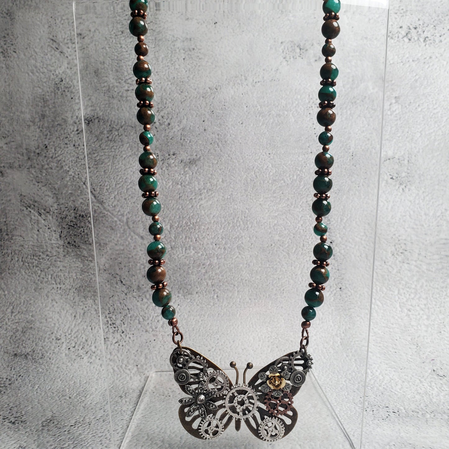 Industrial style necklace with steampunk butterfly pendant and green resin beads