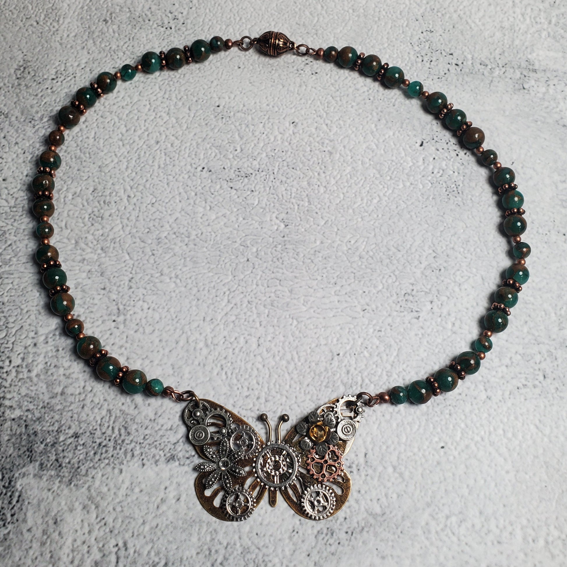 Industrial style necklace with copper mechanical butterfly pendant and green resin sponge quartz beads