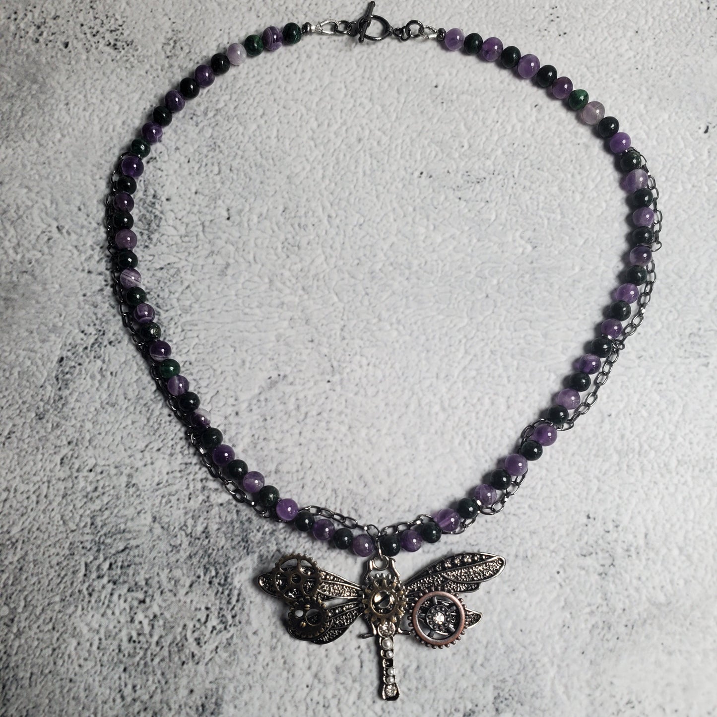 Industrial style necklace with mechanical dragonfly pendant and amethyst gemstones on gunmetal chain