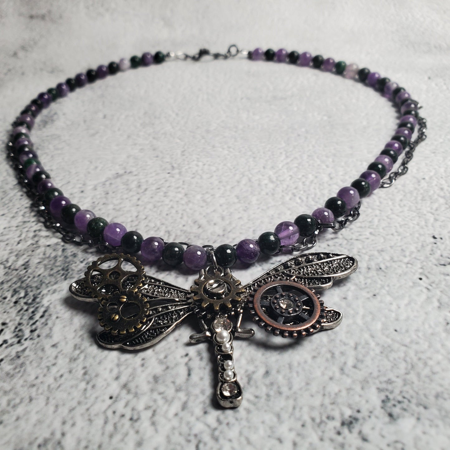 Industrial style necklace with mechanical dragonfly pendant and amethyst gemstones on gunmetal chain