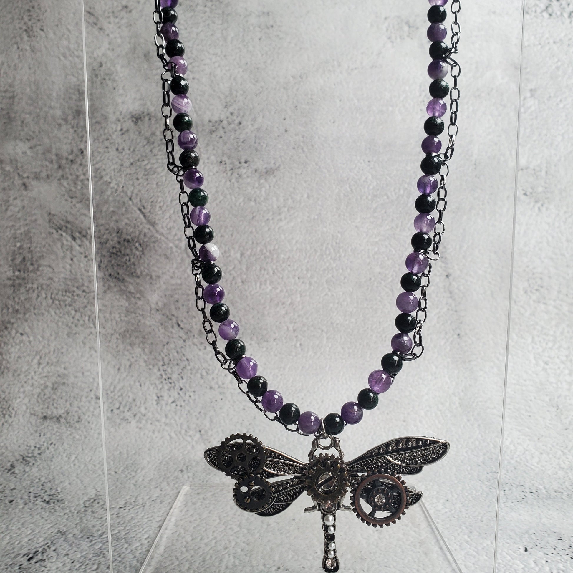 Industrial style necklace with mechanical dragonfly pendant and amethyst gemstones on gunmetal chain