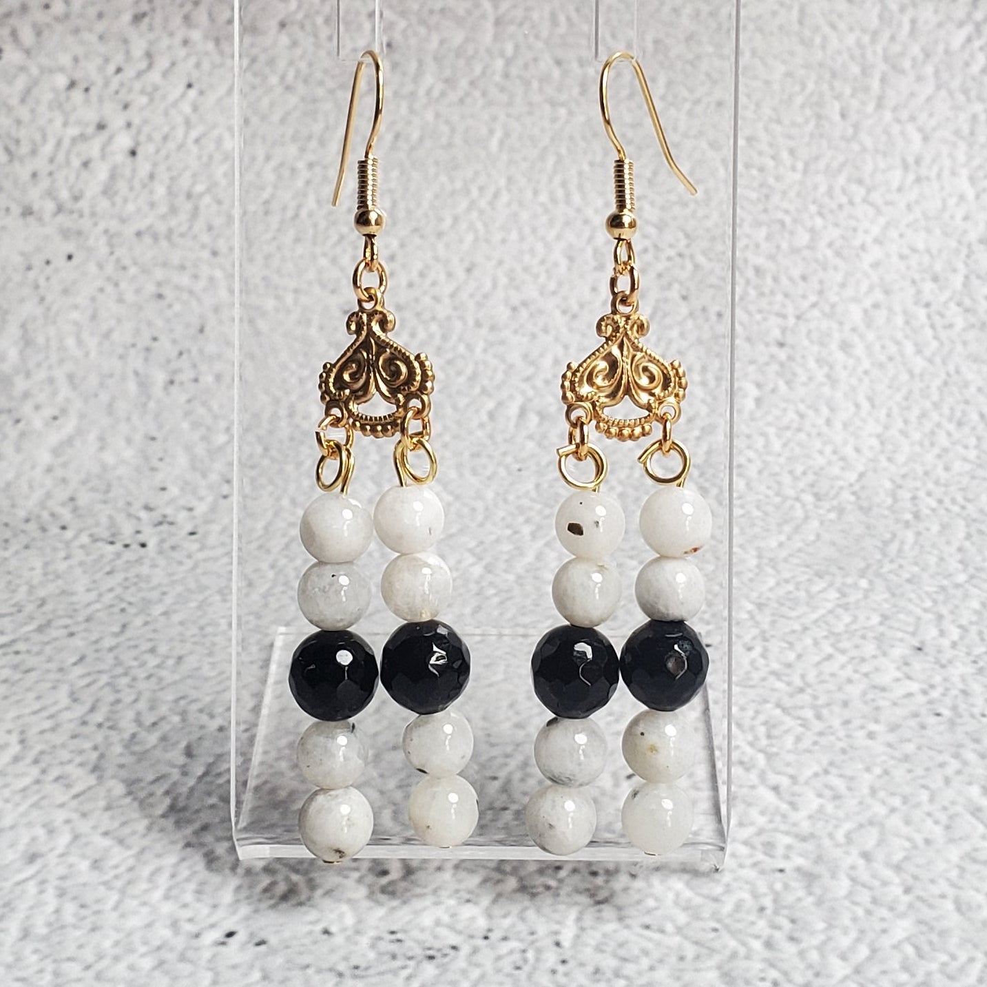 Elegant gemstone earrings with white moonstone and black onyx chandelier design