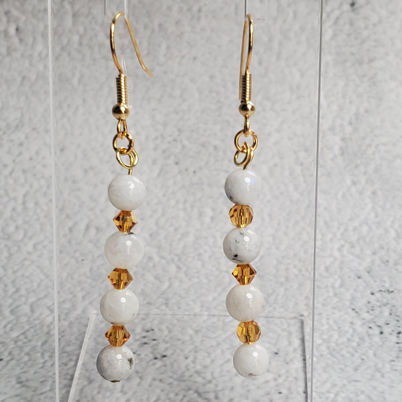 Radiant gemstone earrings featuring white moonstone and warm topaz crystals with hypoallergenic hooks
