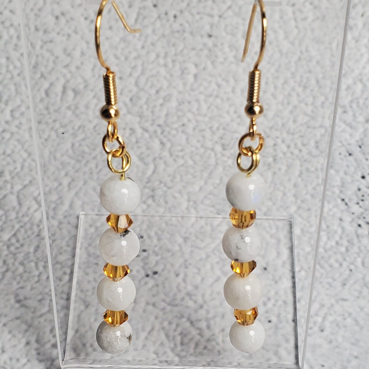 Radiant gemstone earrings featuring white moonstone and topaz-colored crystals with hypoallergenic hooks