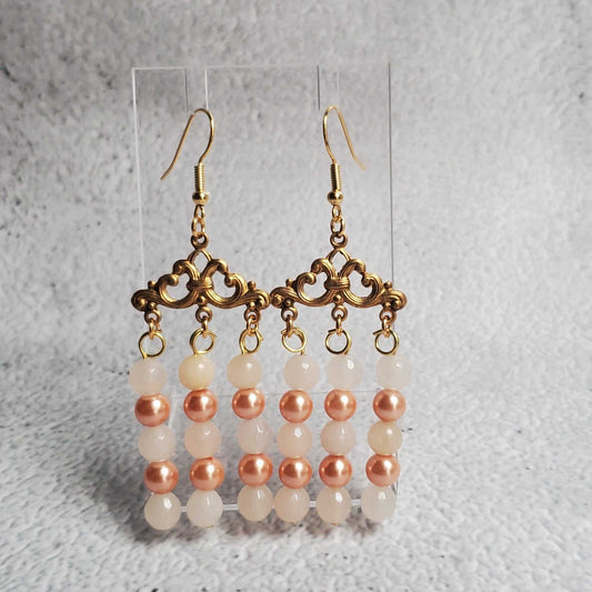 Handcrafted gemstone earrings featuring white moonstone and peach pearl chandelier design with antiqued brass hooks
