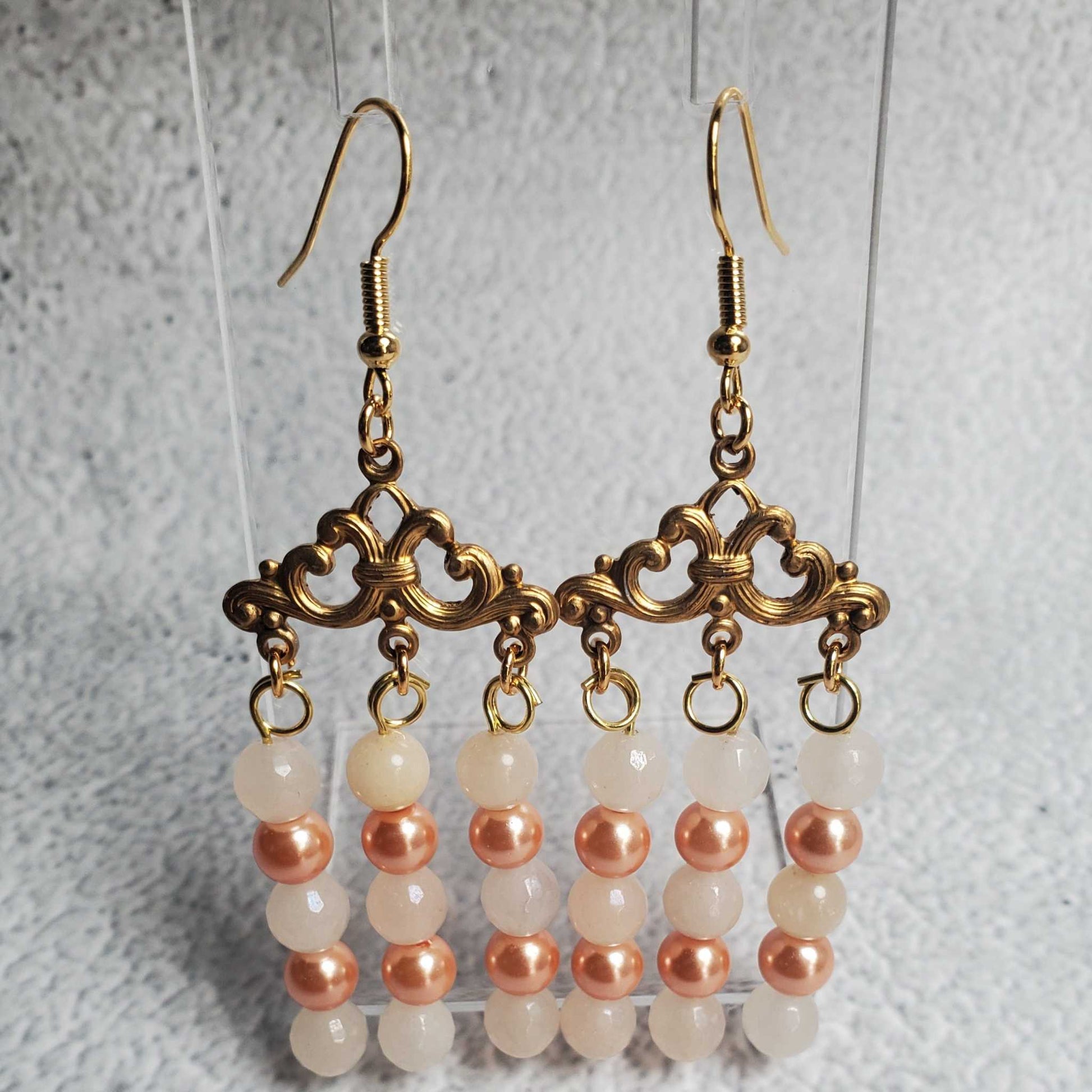 Handcrafted gemstone earrings featuring white moonstone and peach pearl chandelier design with antiqued brass findings