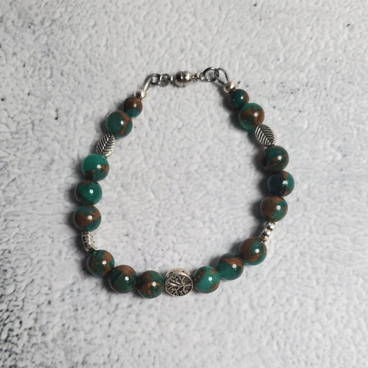 Handcrafted gemstone bracelet featuring green resin sponge quartz and Tree of Life pewter beads with Celtic design