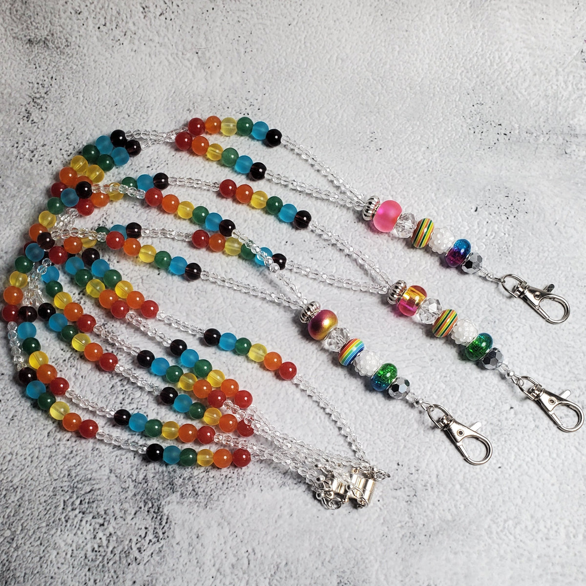 Colorful rainbow lanyard with glass beads and European charm beads, featuring magnetic clasp and lobster claw clip for keys and IDs.