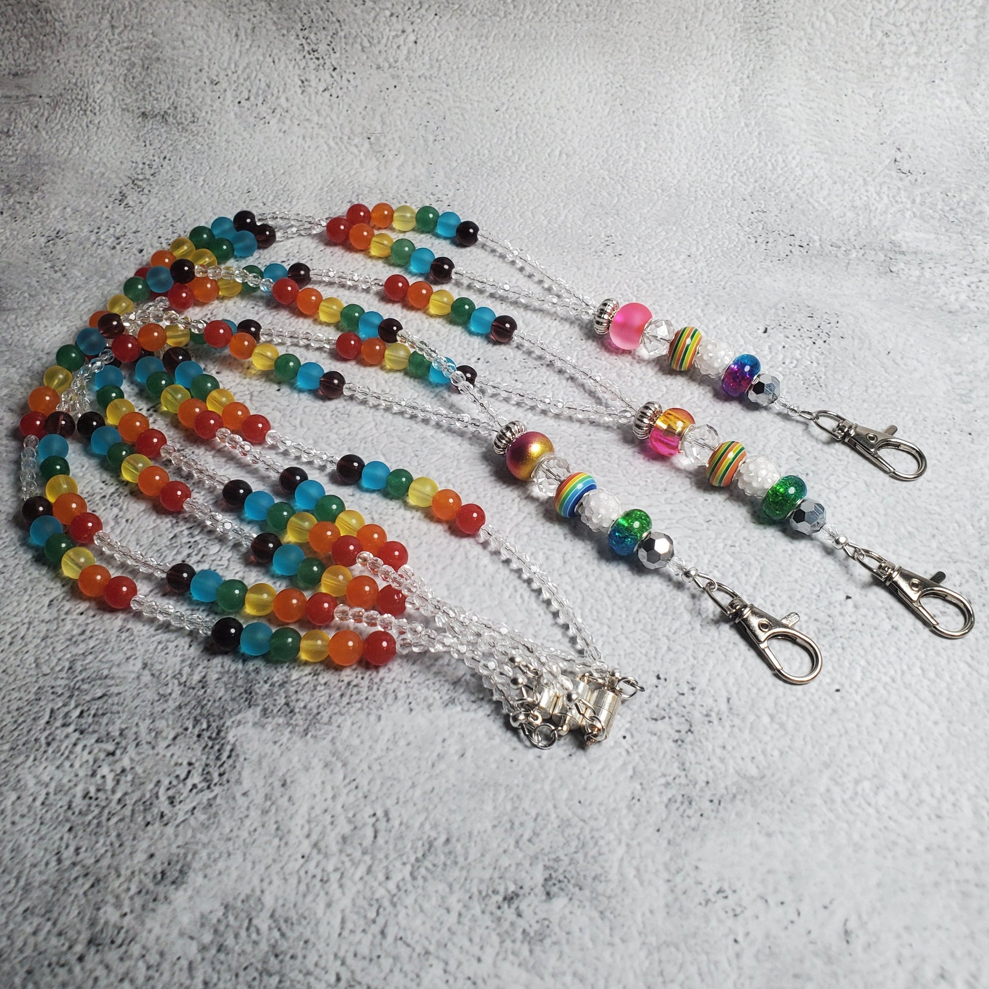 Handcrafted rainbow lanyard with colorful glass beads and European charm beads, featuring a magnetic clasp and lobster claw clasp for keys or ID badges.