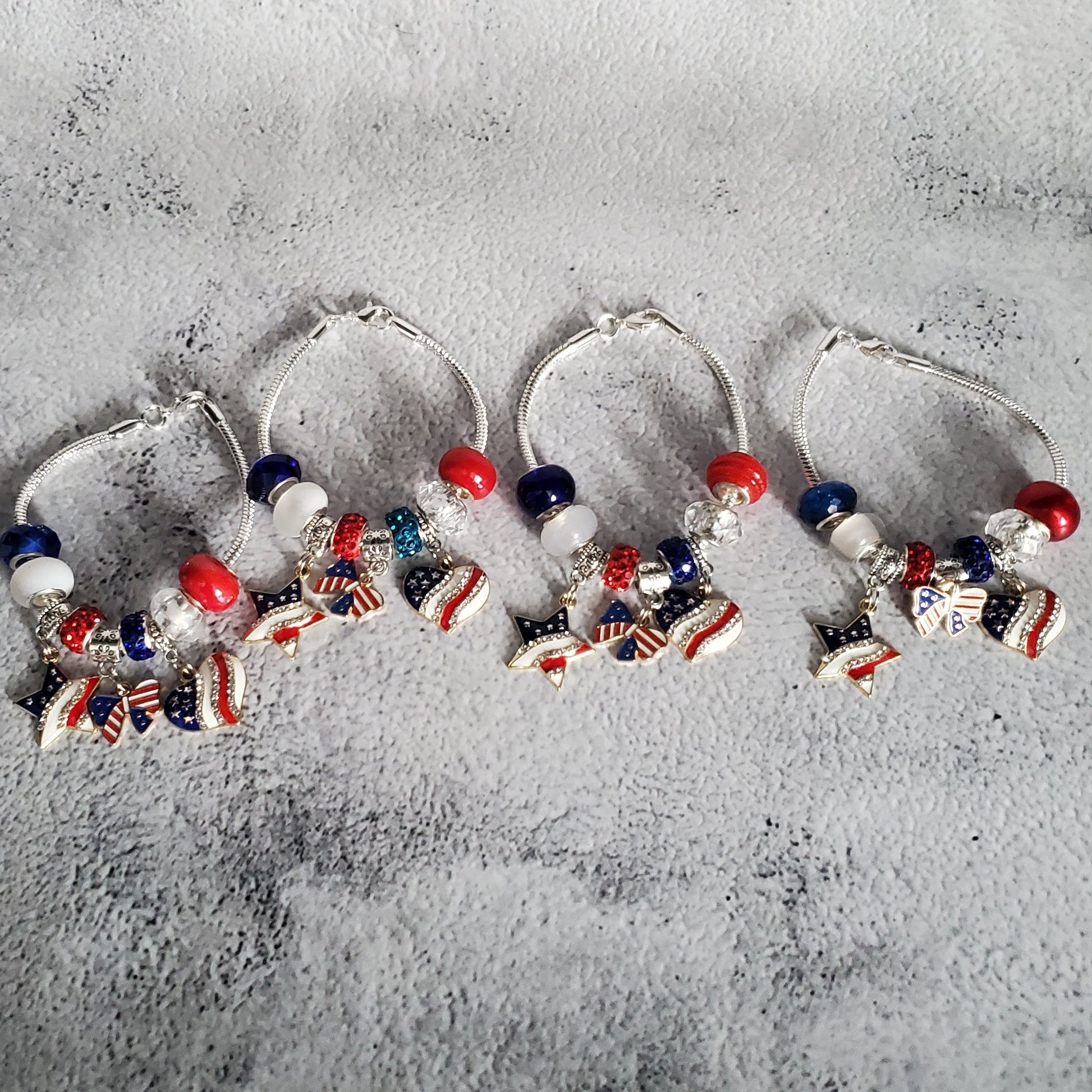 Silver charm bracelet with red, white, and blue beads and American flag rhinestone charms for 4th of July celebration