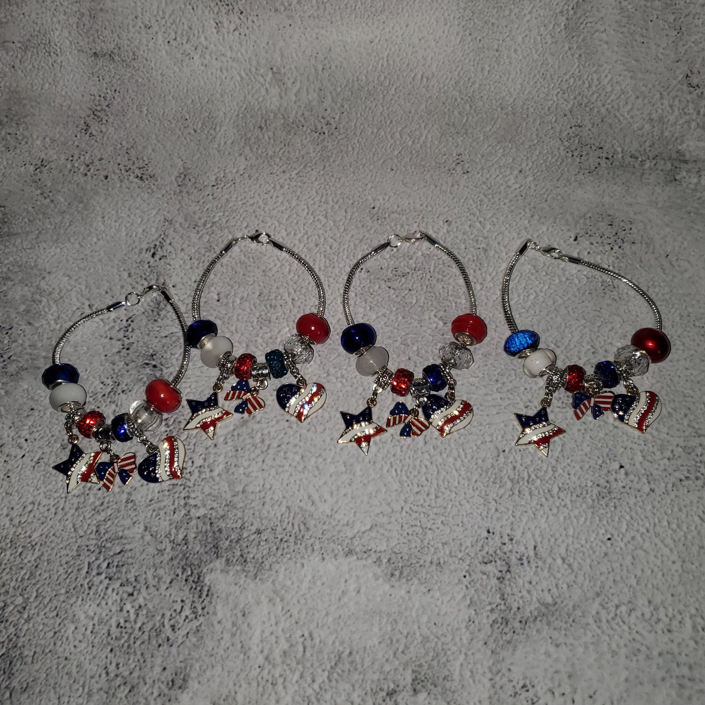 Silver snake chain charm bracelet with red, white, and blue beads and rhinestone American flag charms for 4th of July