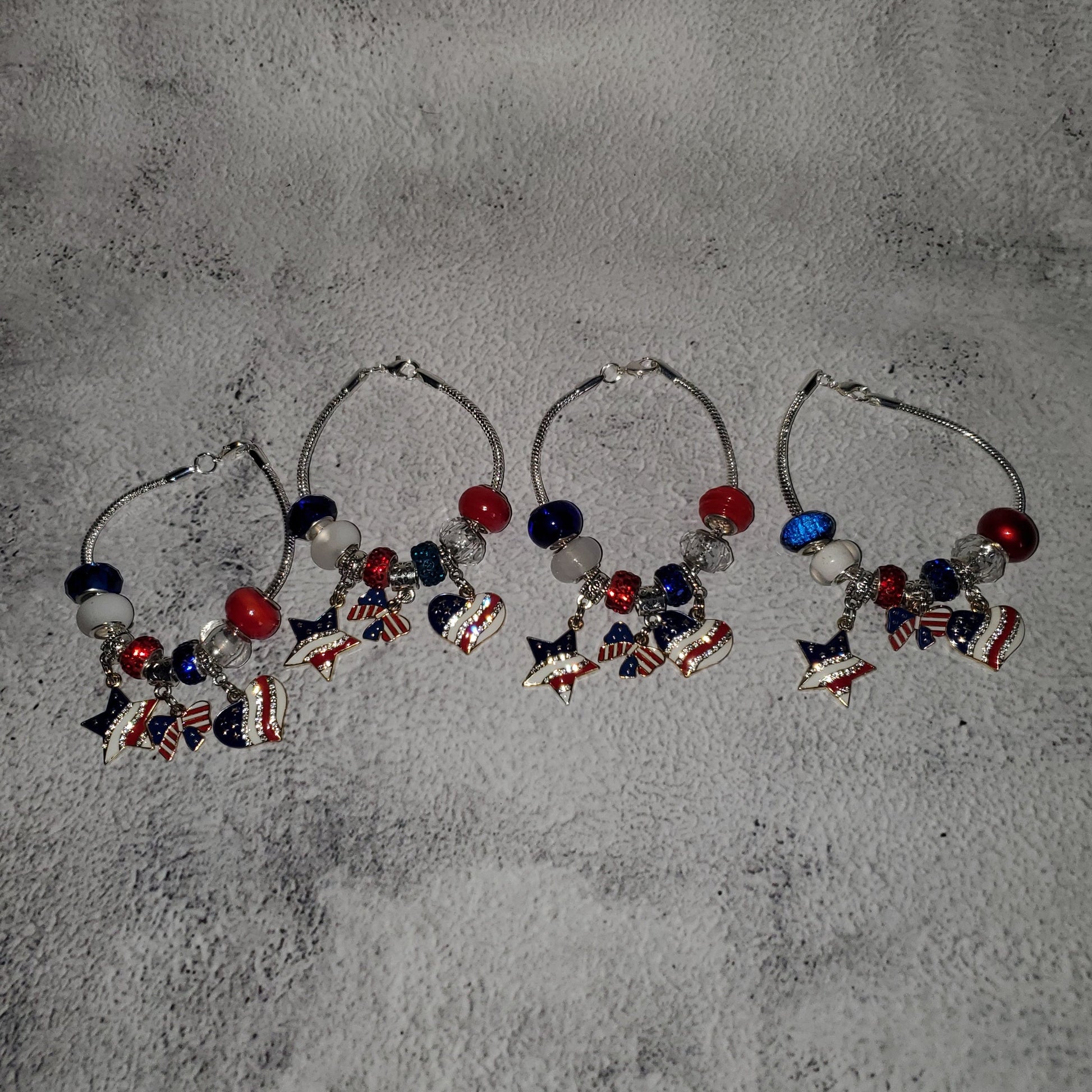 Silver snake chain charm bracelet with red, white, and blue beads and rhinestone American flag charms for 4th of July