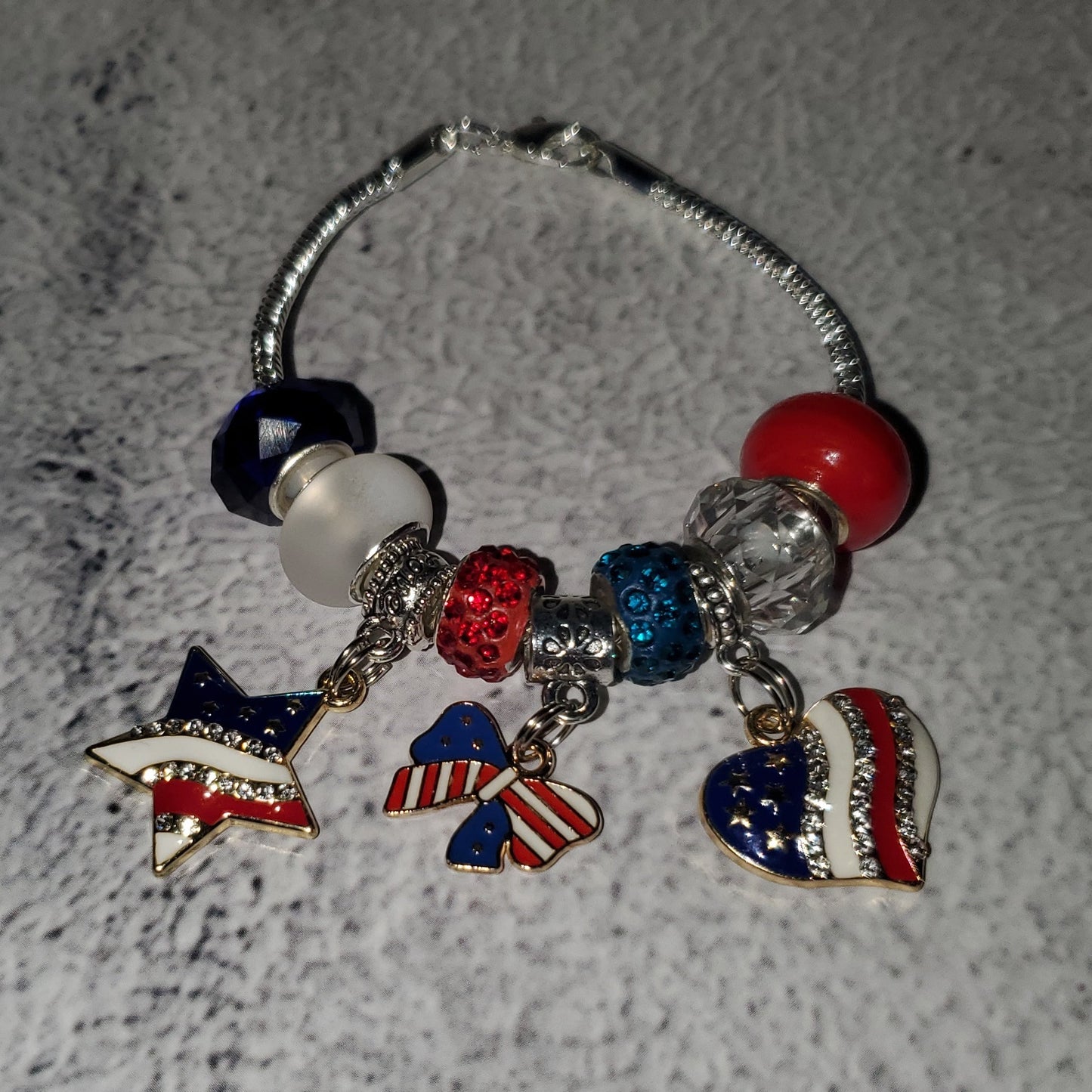 Silver snake chain charm bracelet with red white blue beads and rhinestone American flag charms for 4th of July celebration