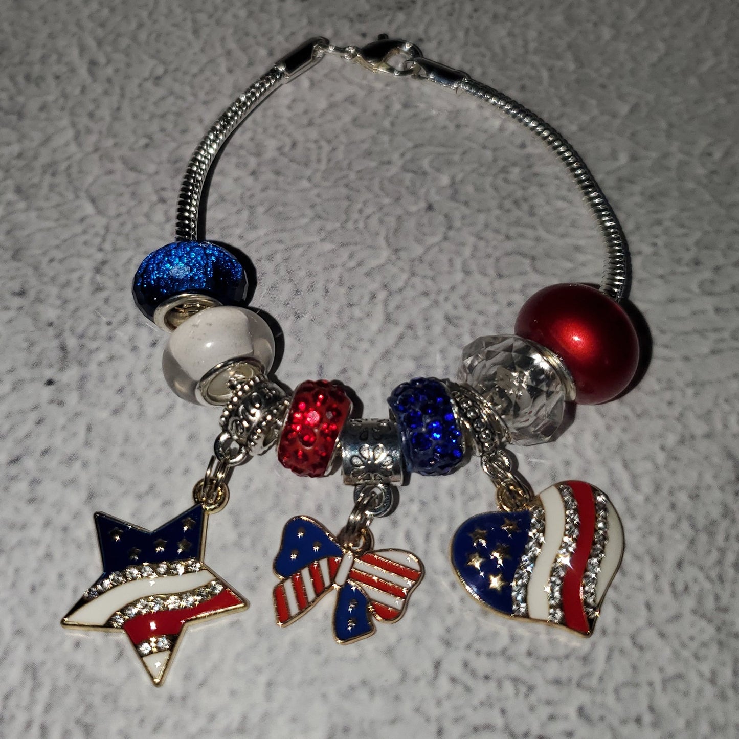 Charm Bracelet 4th of July with red white blue beads and rhinestone American flag charms on silver snake chain