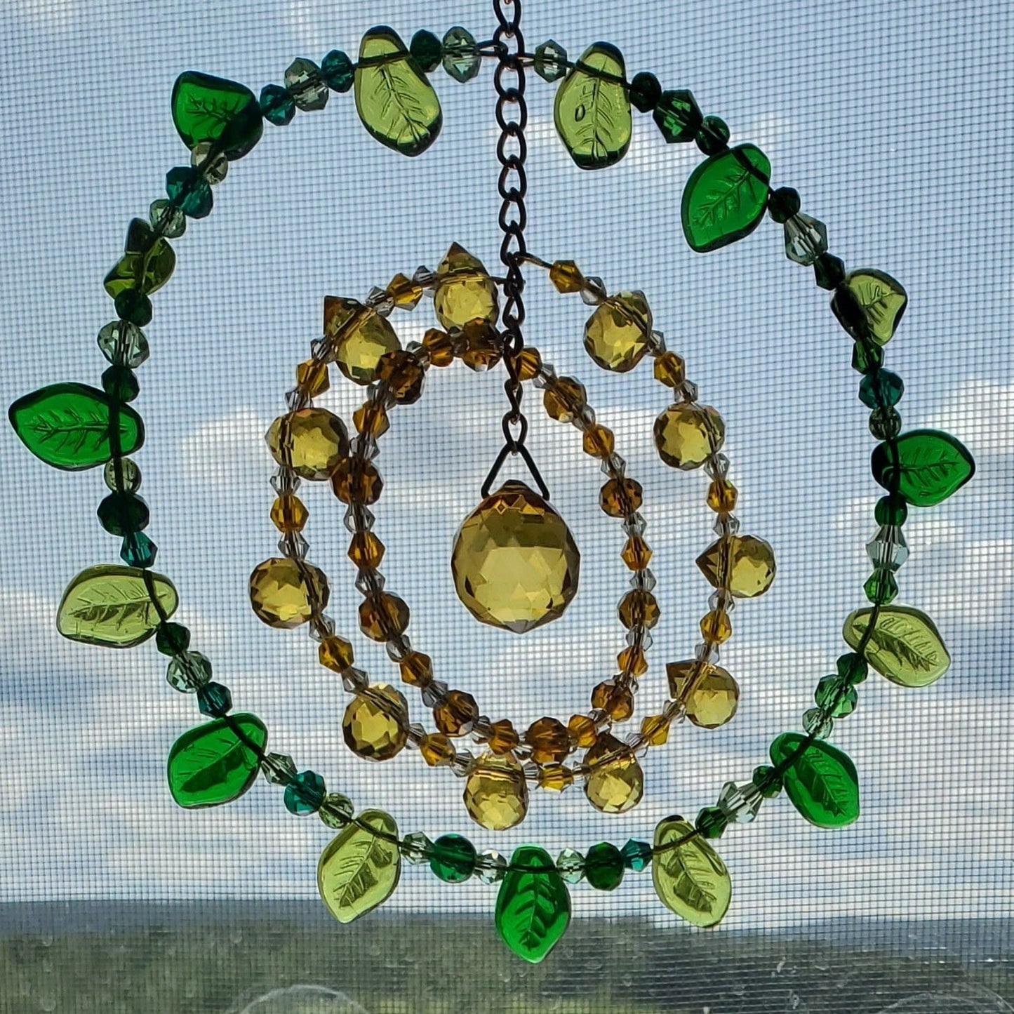 Handcrafted sunflower mandala crystal suncatcher with yellow and green crystals and topaz prism