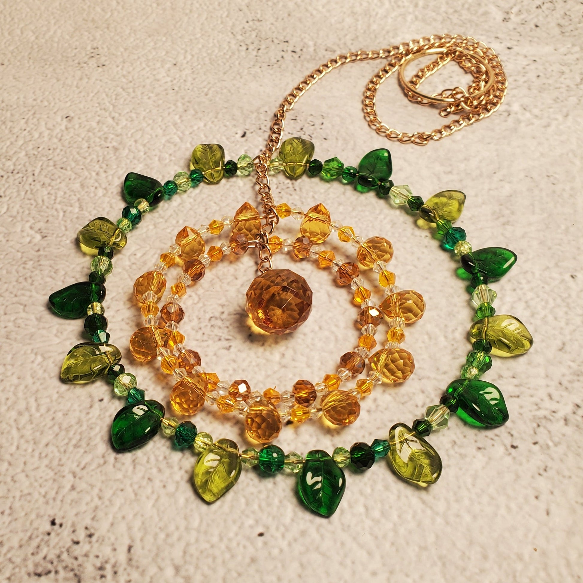 Handcrafted sunflower mandala crystal suncatcher with yellow, amber, and green beads and a topaz prism, 20-inch window decor