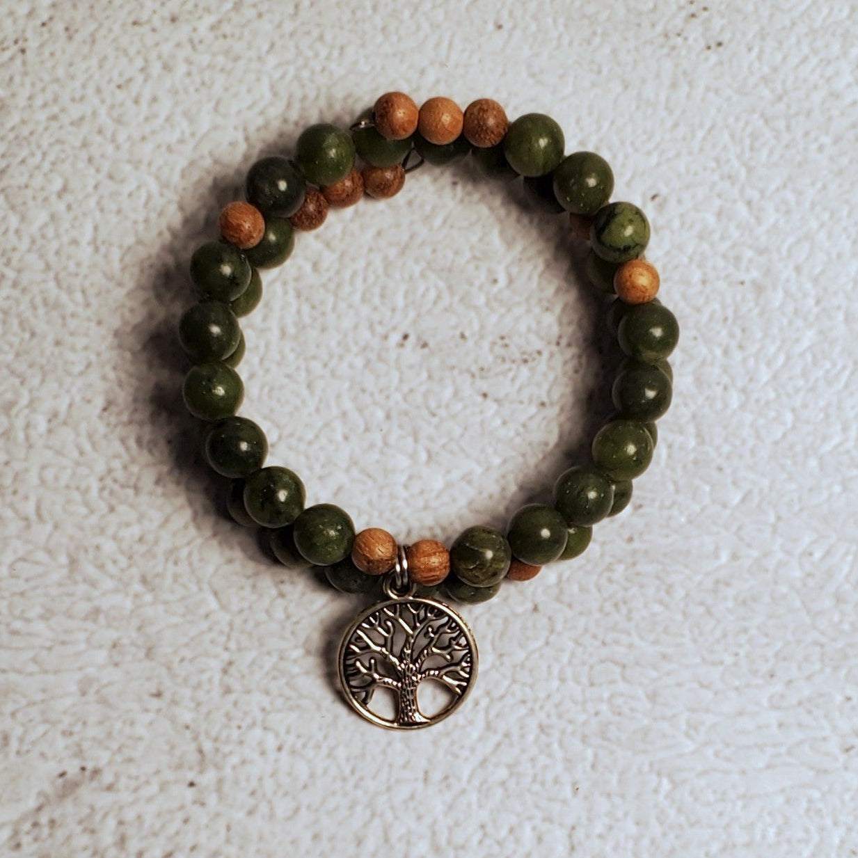 Handcrafted gemstone bracelet with genuine Chinese Jade, natural wood beads, and a pewter Tree of Life charm on flexible memory wire