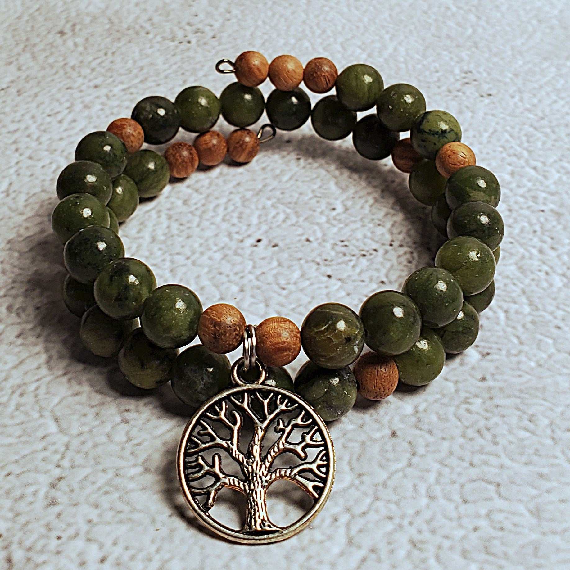 Handcrafted gemstone bracelet with Chinese jade, natural wood beads, and pewter Tree of Life charm on flexible memory wire