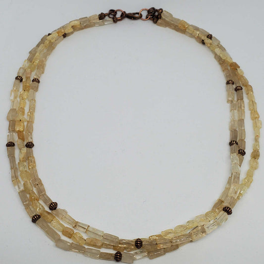Citrine triple strand gemstone necklace with copper accents and vintage-style spacers, 18-inch length with lobster claw clasp.