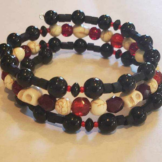Skull bracelet with howlite skull beads, black and red Czech glass accents, adjustable memory wire cuff