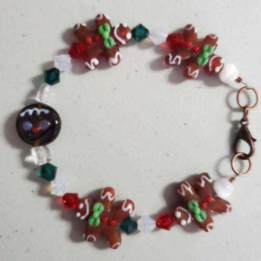 Christmas bracelet featuring gingerbread man lampwork beads, Swarovski crystals, and glass accents with a festive holiday design