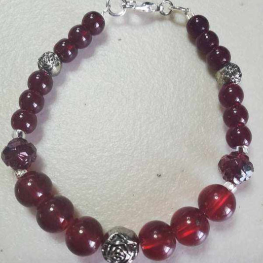Elegant garnet-colored floral bracelet with glass beads, acrylic, and pewter accents, lobster claw clasp for 6.5-inch wrist.