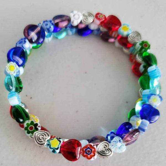Colorful floral bracelet with heart-shaped and Millefiori glass beads on a flexible cuff design