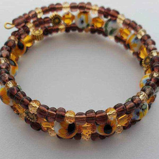 Sunflower Boho cuff bracelet with hand-painted glass beads, brown Czech glass, and Swarovski crystals on memory wire base