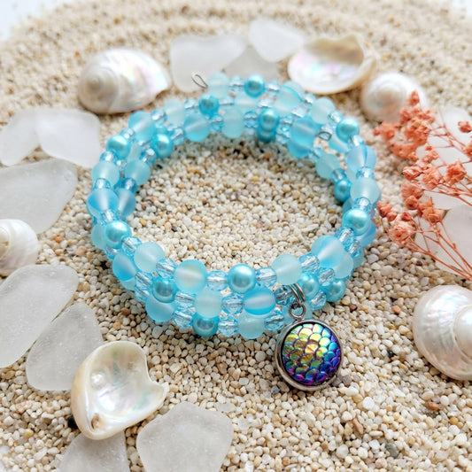 Crystal Aura Mermaid Charm Bracelet with iridescent blue beads and mermaid scale charm on memory wire.