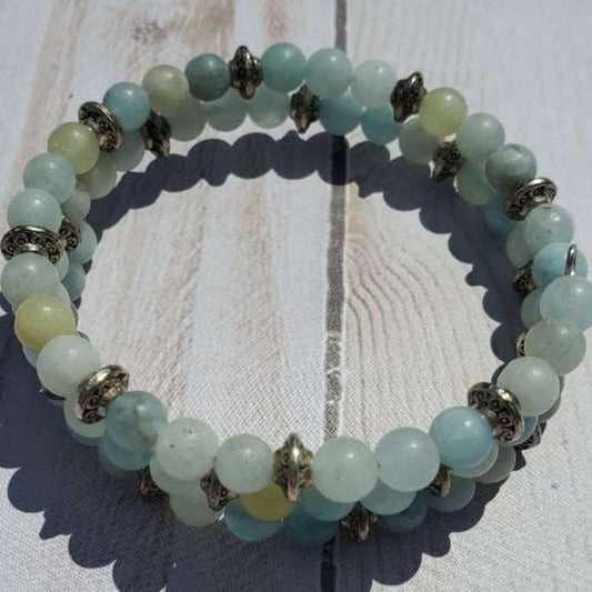 Aquamarine Cuff Gemstone Bracelet with genuine beads and pewter accents on wooden background.