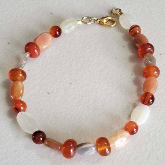 Carnelian and Moonstone gemstone bracelet with brass accents and lobster claw clasp.
