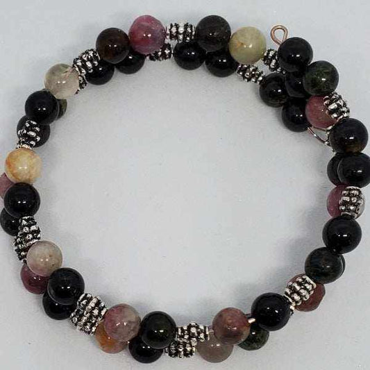 Tourmaline gemstone bracelet with black and pink beads, pewter spacers, and memory wire cuff design