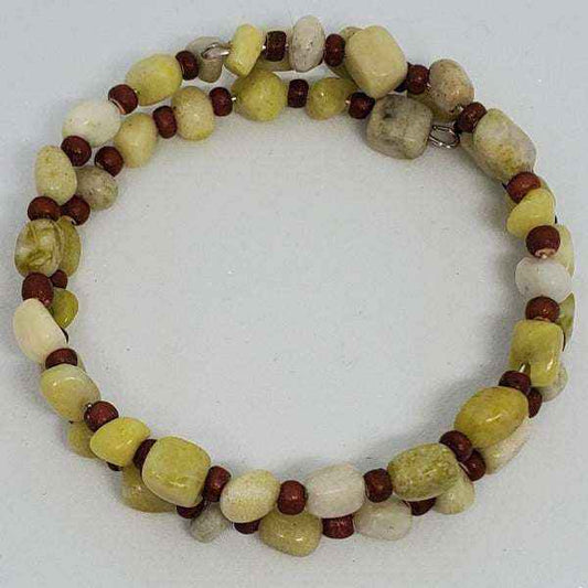 Gemstone bracelet featuring serpentine stones and coconut wood beads in a flexible cuff design