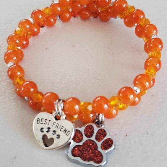 Orange bead charm bracelet with paw print and heart-shaped "Best Friend" charms