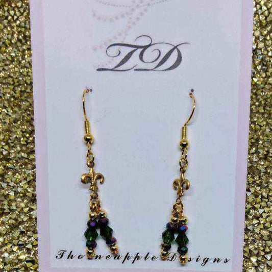 Drop style Mardi Gras earrings with purple and green crystals, glass beads, and gold Fleur-de-lis charm on gold hooks.